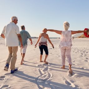 groupe de seniors se promenant sur la plaqe en été